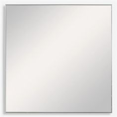 a white square mirror hanging on the wall