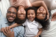 a group of people laying on top of each other with their arms around one another