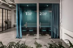 two room divider with blue curtains and chairs