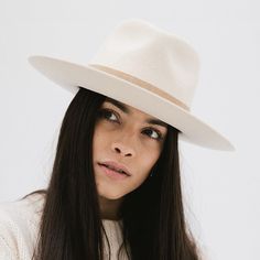 Elevate your style with the Holly Rancher Hat. The semi-tall fedora crown and mid-length upturned brim make this hat the perfect blend of bold and approachable. The hand-sewn suede band adds a touch of sophistication, making it easy to pair with any accessory. A must-have for hat wearers of all levels! brim, ivory, cream, white, fedora, felt, wool, stiff White Fedora, Rancher Hat, Dash And Albert, Felt Wool, Cream White, Hand Sewn, Custom Fit, Mid Length, Fedora