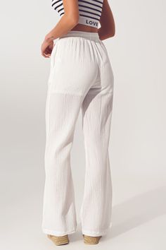 Introducing our Textured Wide Leg Pants in White, the perfect addition to your daily wardrobe. Made from 100% cotton, these pants offer a lightweight woven fabric that is both comfortable and breathable. The relaxed fit, straight design, and full length make these pants versatile for any occasion, from casual outings to dressier events. The functional side pockets provide a convenient place for storing small items, while the drawstring closure and elasticated waist ensure a comfortable and secur Europe Clothes, Statement Blouse, Stylish Pants, White China, Pantalon Large, Everyday Wardrobe, Belted Dress, Large White, Fashion Details