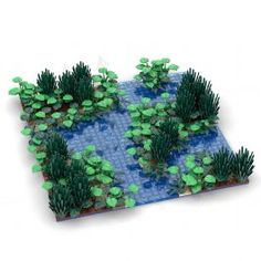 a lego model of a pond with plants growing out of it