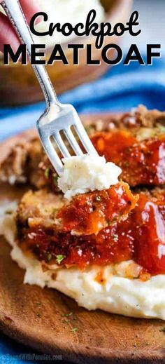 crockpot meatloaf on a wooden board with a fork