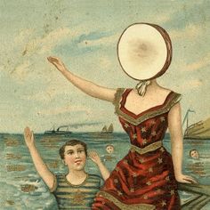 a woman floating on top of a body of water next to a man in a boat