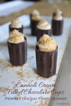 chocolate desserts with white frosting and gold sprinkles on a plate