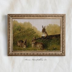 a painting of two rabbits sitting in the grass