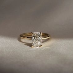 a gold ring with a princess cut diamond