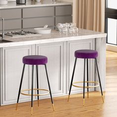 two purple stools sit in front of an island with marble countertops and white cabinets