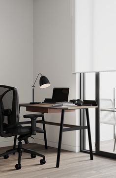 an office with a desk, chair and laptop on the table in front of a window