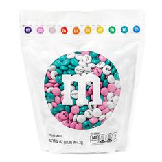 a bag of m & m's with pink, white and blue sprinkles