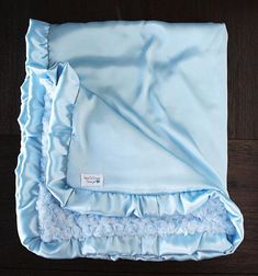 a blue blanket with white pom poms on it