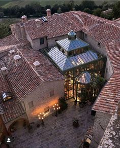 an aerial view of a building with many lights on it's roof and windows