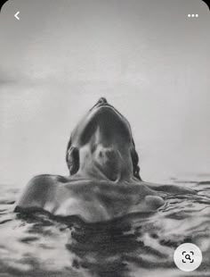 a black and white photo of a shark swimming in the ocean with its mouth open