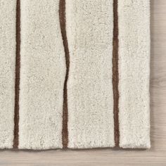 a white rug with brown stripes on it