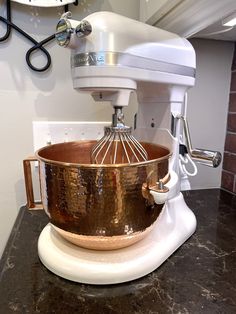 a kitchen mixer sitting on top of a counter