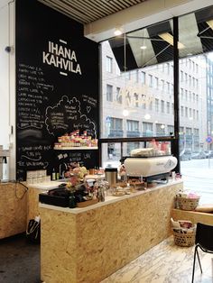 the inside of a coffee shop with chalk writing on the wall