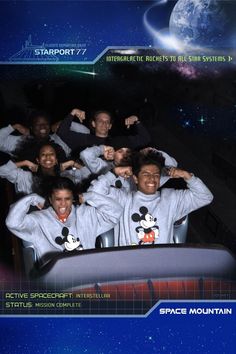 the cast of disney's space mountain poses for a photo in front of an image of mickey mouse