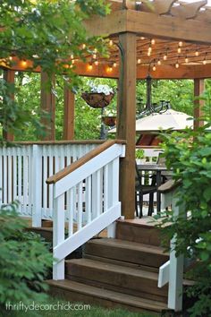 an outdoor deck with stairs and string lights