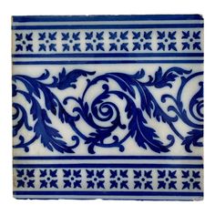 a blue and white tile with designs on it