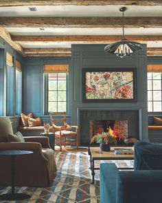 a living room filled with furniture and a fire place in the middle of a room