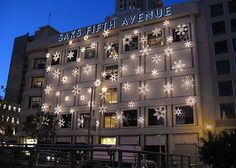 a large building with snowflakes on it's side and lights in the windows