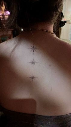 a woman with a star tattoo on her back