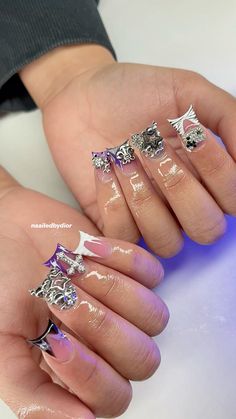 a woman's hands with manicured nails and nail art designs on their fingers