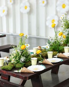 the table is set with flowers and cups