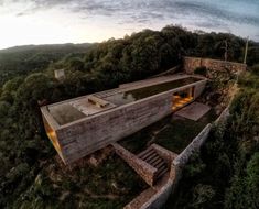 an aerial view of a house on top of a hill