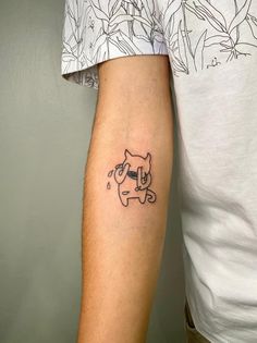 a man with a cat tattoo on his arm, holding onto another person's arm