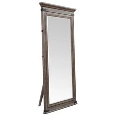 a tall mirror sitting on top of a wooden floor