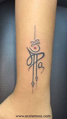 a tattoo on the foot of a woman with an omen symbol in black ink