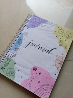 a spiral notebook with the words journal written on it