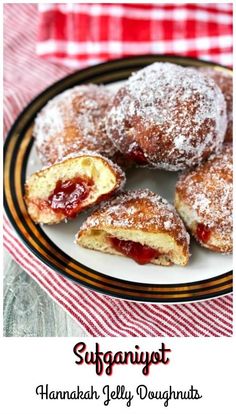 some powdered sugar covered pastries on a plate with a red and white checkered table cloth