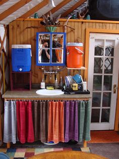 a room with a sink, mirror and other items on the table in front of it