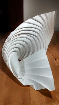 a white sculpture sitting on top of a wooden floor