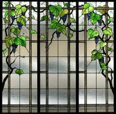 a stained glass window with vines and leaves