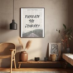 an empty room with a chair, table and poster on the wall above it that reads embrace the journey