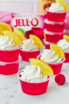 small cups filled with whipped cream and lemon wedges