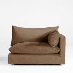 a brown couch with two pillows on it's back and one arm folded up