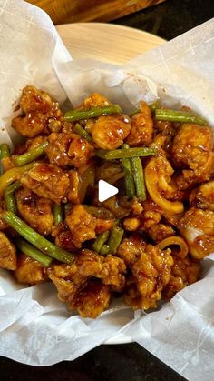 chicken and green beans in a paper bowl