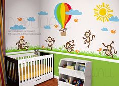 a baby's room decorated with monkeys and hot air balloons