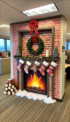 an office decorated for christmas with stockings and wreaths on the fire place in front of a brick fireplace