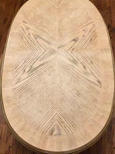 a round wooden table sitting on top of a hard wood floor