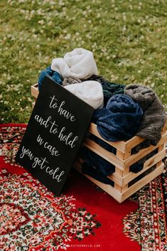 a sign that says to have and to hold in case you getceld on top of a crate filled with clothes