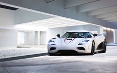 a white sports car parked in a garage