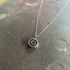 Reclaimed sterling silver that I melted down myself and hammered into a disc shape with an added sterling silver spiral. I then oxidized, tumbled and polished the pendant for extra dimension and to bring out the textures of the recycled silver. I love the rustic organic feel of this spiral necklace. The pendant comes on a dainty 18 inch sterling silver chain. This necklace will be made from melted down and forged sterling silver just for you! Each one will be as unique as you, but will based on Pierced Pendant Designs, Cool Silver Necklaces, Adjustable Silver Necklace, Funky Silver Jewelry, Silver Dainty Jewelry, Handmade Spiral Silver Jewelry, Minimalist Silver Spiral Necklace, Elegant Sterling Silver Spiral Necklace, Unique Silver Spiral Necklace