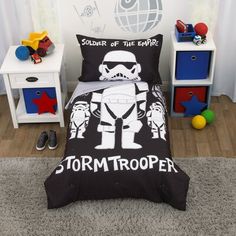 a bedroom with star wars themed bedding and toys