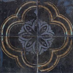 a black and gold tile with an intricate design on the bottom half, in different colors