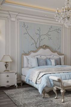 a bedroom with white furniture and chandelier